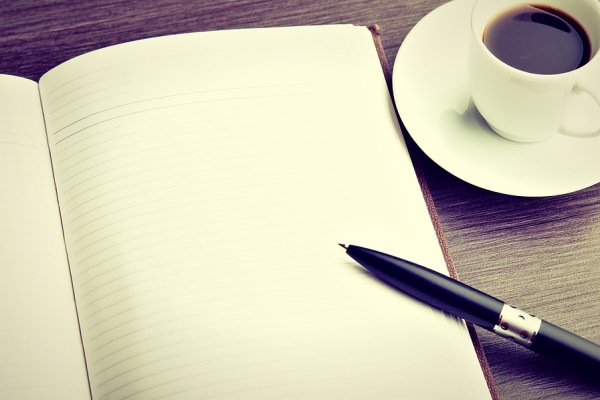 Open A Blank White Notebook, Pen And Coffee On The Desk